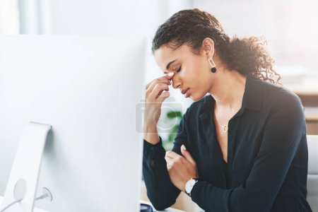 Photo for I really need to find relief from this pain. a young businesswoman looking stressed out while working in an office - Royalty Free Image