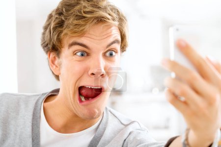 Photo for Life is long be silly. a young woman making funny faces while taking selfies with his smartphone - Royalty Free Image