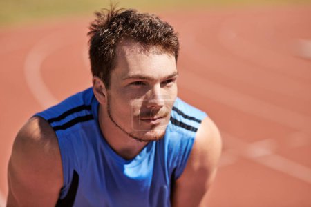 Photo for Hes ready to race. a handsome young runner out on the track - Royalty Free Image