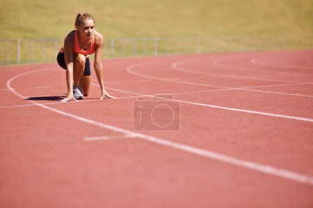 Photo for Ready for a race. an attractive young runner out on the track - Royalty Free Image