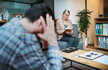 Photo for Buried emotions eventually come back. a young man having a therapeutic session with a psychologist and looking upset - Royalty Free Image