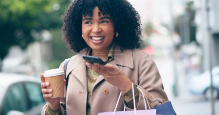 Photo for Happy woman, coffee and phone for communication for outside, city and street for commute. African, business person and smile with shopping bags while talking on mobile with app, network or internet. - Royalty Free Image