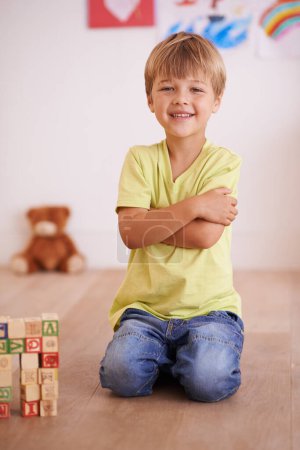 Photo for Future civil engineer. A little boy sitting proudly next to a tower he built - Royalty Free Image