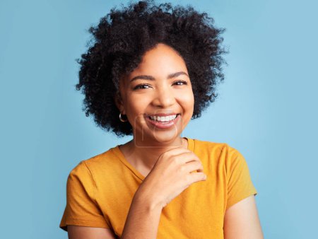 Photo for Happy, smile and portrait of a woman in a studio with a positive, good and confident mindset. Happiness, excited and headshot of a young female model with an afro from Colombia by a blue background - Royalty Free Image