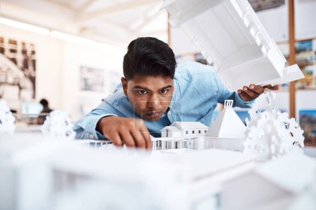 Photo for The better the quality, the higher the customer satisfaction. a young architect designing a building model in a modern office - Royalty Free Image