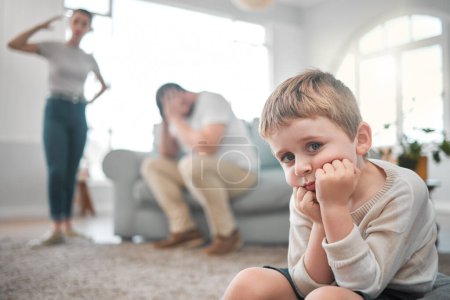 Photo for A persons a person, no matter how small. a little boy looking sad while his parent argue at home - Royalty Free Image