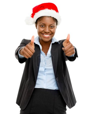 Photo for Merry Christmas from our company to yours. Studio shot of a confident young businesswoman wearing a Santa hat and showing thumbs up against a white background - Royalty Free Image