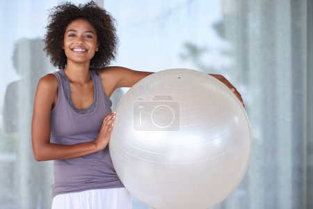 Photo for Nothing beats the exercise ball. Cropped portrait of an attractive young woman standing with an exercise ball - Royalty Free Image