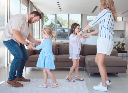 Photo for Caucasian family of four having fun and dancing together in the living room at home. Happy little playful girls bonding with mom and dad. Carefree loving parents entertaining their energetic daughter. - Royalty Free Image
