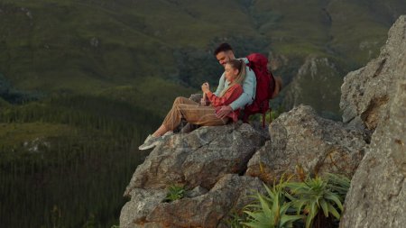 Photo for Hiking, mountain and love, couple relax on outdoor adventure and peace in nature with romance. Trekking, rock climbing and view, man and woman with view of natural landscape sitting on cliff together. - Royalty Free Image