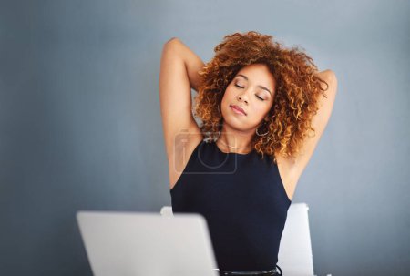 Photo for Good things come to those who work for it. a young businesswoman feeling relaxed at her desk - Royalty Free Image