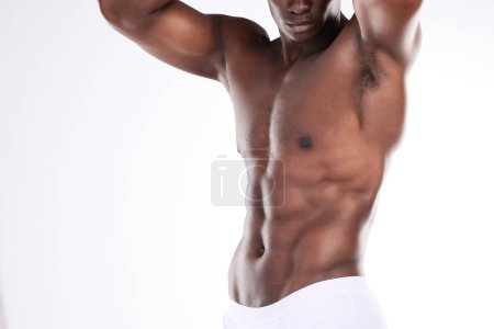 Photo for Super stud. an unrecognizable man showing off his muscular body while posing against a white background - Royalty Free Image