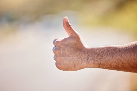 Photo for I just need to get out of here. Closeup shot of an unrecognisable man showing thumbs up outdoors - Royalty Free Image