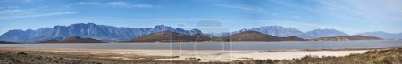Photo for It is a sad time indeed. a desolate landscape during the day with a small dried out dam in the middle - Royalty Free Image