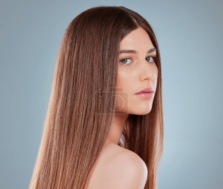 Photo for I maintain a healthy haircare routine. Studio shot of a beautiful young woman showing off her long brown hair - Royalty Free Image