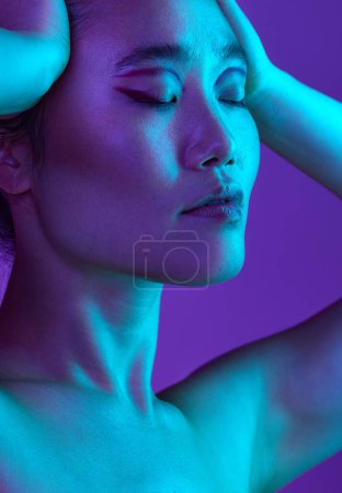 Photo for Bought a brand new attitude. an attractive young woman posing in studio against a purple background - Royalty Free Image