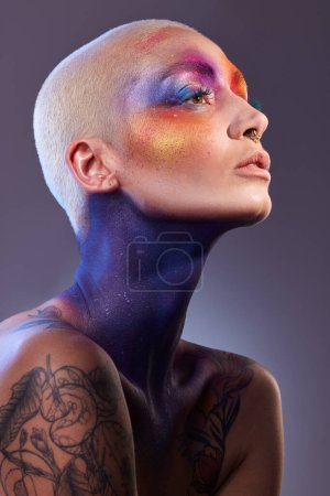 Photo for Shes a colourful soul. Studio shot of a young woman posing with multi-coloured paint on her face - Royalty Free Image