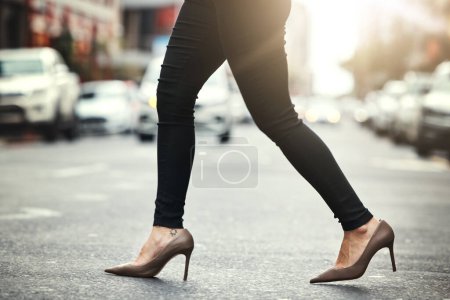 Photo for High heels, business and woman crossing the street closeup in a city on her commute to work. Feet, fashion and a female employee walking on an asphalt road in an urban town for a professional career. - Royalty Free Image