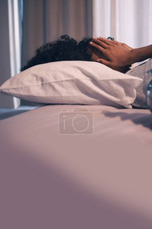 Photo for Tired, burnout and woman sleeping in bed with exhaustion, depression or insomnia at home. Rest, relax and stressed female person taking nap for mental health in the bedroom of her house or apartment - Royalty Free Image