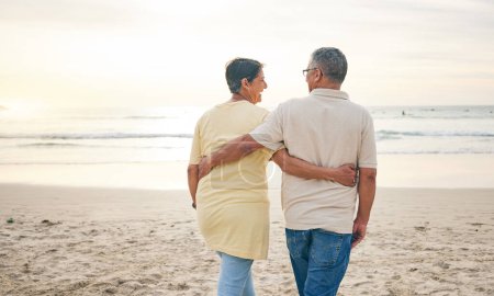 Photo for Beach, hug and rear view of senior couple with love, bond and happy while walking in nature together. Back, embrace and old people enjoy retirement with ocean travel, vacation and holiday at the sea. - Royalty Free Image
