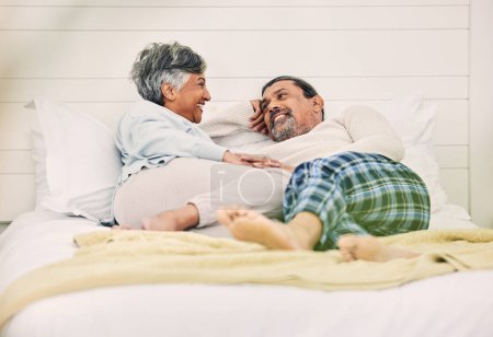 Photo for Talking, happy or old couple in bedroom to relax, enjoy romance or morning together at home. Holding hands, senior woman or elderly man laughing or bonding with love, support or smile in retirement. - Royalty Free Image