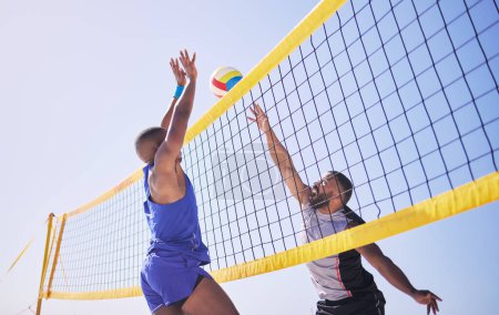 Photo for Jump, hit and beach, volleyball and men at net with sports action, fun and summer competition with blue sky. Energy, ocean games and volley challenge with athlete hitting ball for goal in nature - Royalty Free Image