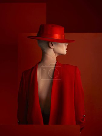 Photo for Back, fashion and space with a woman on a red background in studio for marketing, advertising or branding. Luxury, aesthetic style or a trendy young female model standing with empty or blank mockup. - Royalty Free Image