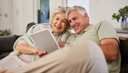Photo for Senior man, woman or tablet on sofa to download news app, reading social media post or ebook. Happy elderly couple scroll website on digital technology, internet blog or online shopping in retirement. - Royalty Free Image