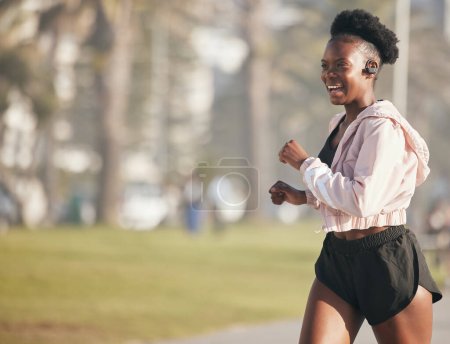 Photo for Black woman, fitness and running outdoor with earphones for listening to music, radio or podcast. Sports, smile and happy African athlete training, workout and exercise for health, wellness or cardio. - Royalty Free Image