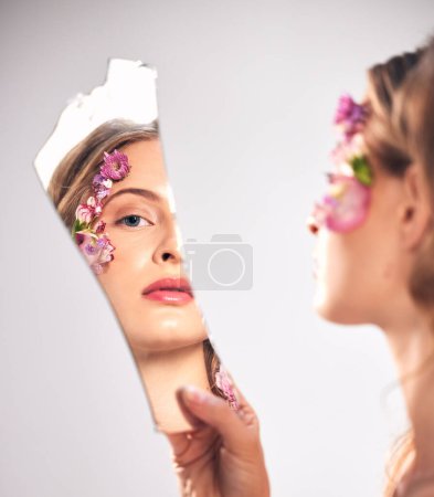 Photo for Beauty, reflection and portrait of a woman with a broken mirror for an insecurity and problem. Mental health, makeup and face of a girl getting ready and looking at face isolated on a background. - Royalty Free Image