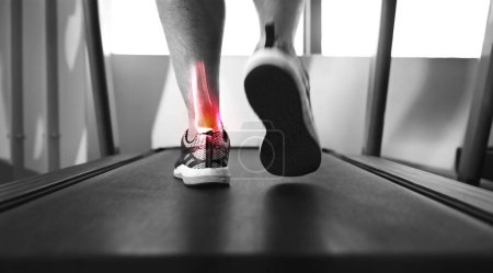 Photo for Closeup, treadmill and ankle with pain, injury and muscle tension with person walking, exercise and training. Zoom, athlete or foot with red highlight, gym equipment or strain after practice and ache. - Royalty Free Image