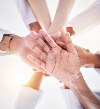 Photo for Healthcare, teamwork and below hands of doctors for support, partnership and medicine trust. Motivation, success and medical workers in hand gesture for solidarity, mission and collaboration goals. - Royalty Free Image