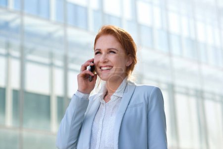 Photo for Business woman, phone call and talking in city, street or town with contact outdoors. Technology, thinking and happy female entrepreneur with 5g mobile smartphone for networking, chat and discussion - Royalty Free Image