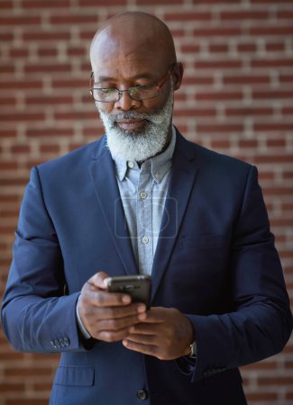 Photo for Startup, black man and manager with smartphone, online reading and connection for typing. Mature male, African American employee or leader search internet, success or small business with entrepreneur. - Royalty Free Image