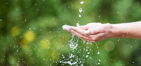 Photo for Woman, hands and palm with water for natural sustainability, washing or cleanse in nature. Closeup of female person with falling liquid drops for sustainable eco friendly environment in the outdoors. - Royalty Free Image