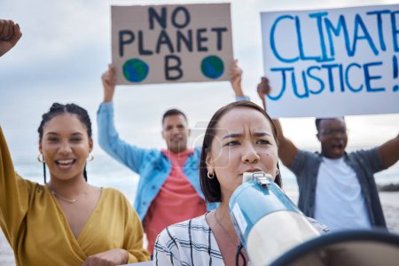 Photo for Megaphone, climate change protest and Asian woman with crowd at beach protesting for environment and global warming. Save the earth, group activism and people shouting on bullhorn to stop pollution - Royalty Free Image