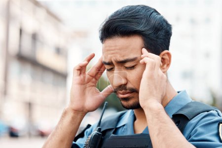 Photo for Stress, danger or policeman in city with headache, anxiety or burnout working for justice or law enforcement. Tired cop, legal or security guard with head pain, emergency crisis or migraine on street. - Royalty Free Image