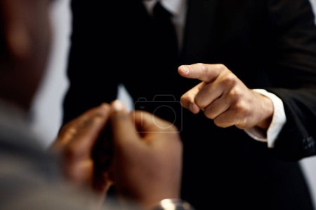 Photo for Criminal, hands pointing at man and interrogation with police officer, detective or lawyer with handcuffs. Anger, law questions and prisoner at arrest, men in legal interview for crime investigation - Royalty Free Image