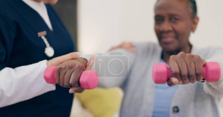 Photo for Caregiver, senior woman or dumbbell on bed to help, exercise or wellness in physiotherapy. Nurse, black person or fitness support in home in physical therapy, care or elderly patient in healthcare. - Royalty Free Image