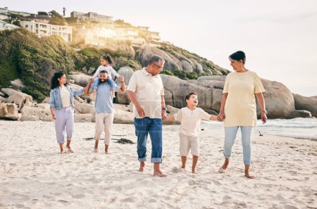 Photo for Big family, holding hands and walking at a beach for travel, vacation and fun in nature together. Freedom, parents and children relax with grandparents at the sea on holiday, trip or ocean adventure. - Royalty Free Image