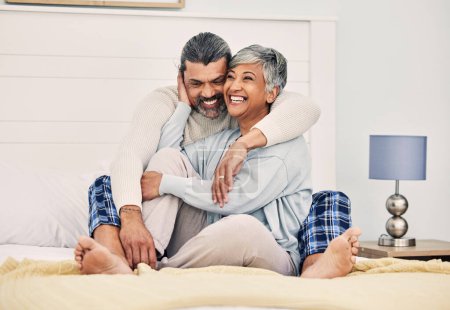 Photo for Hug, happy or old couple in bed to relax, enjoy romance or morning time together at home in retirement. Embrace, senior woman or funny elderly man laughing or bonding with love, support or smile. - Royalty Free Image