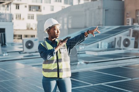 Photo for Black woman point, solar panel and speaker phone call for photovoltaic plate, renewable energy grid or project voice note. Rooftop view, cellphone and female engineer talk about construction building. - Royalty Free Image