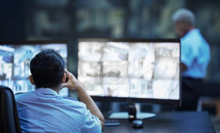 Photo for Security guard in control room, man checking cctv screen in surveillance office for building safety. Inspection, technology and video stream to monitor crime, privacy and night protection service - Royalty Free Image