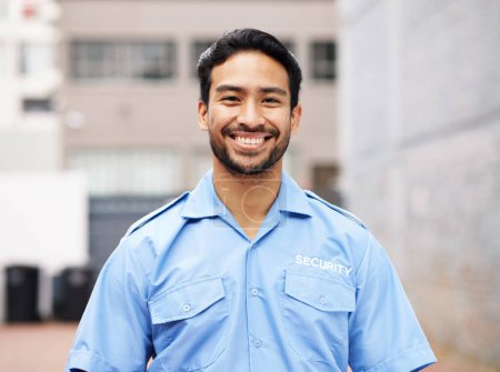 Photo for Portrait, man and happy security guard for police service, crime protection and urban safety in city street. Law enforcement, professional bodyguard and asian male officer smile in blue shirt outdoor. - Royalty Free Image