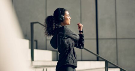 Photo for Runner woman, headphones and stretching on stairs for music, vision and idea in city, workout or training. Girl, thinking and listen on steps with audio streaming subscription, wellness and exercise. - Royalty Free Image