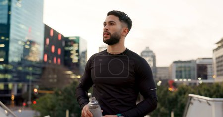 Photo for Fitness, face and thinking, man in city on rest from morning workout with water bottle. Relax, breathing and tired athlete with calm urban exercise with fatigue, reflection and drink on street. - Royalty Free Image