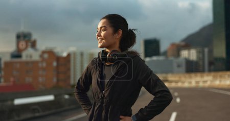 Photo for Training, city smile and outdoor woman looking at view, buildings and happy for morning cardio, wellness or workout. Happiness, fitness and urban athlete, runner or person exercise in Chicago, USA. - Royalty Free Image