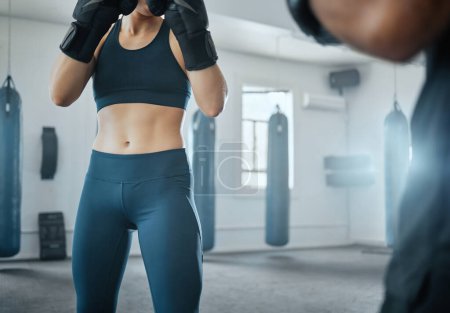 Photo for Female fitness boxing with trainer, learning self defense with coach at gym and training for wellness at a sports center with an instructor. Man teaching an athletic woman to fight and do cardio. - Royalty Free Image