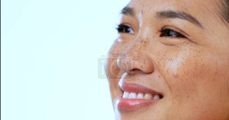 Photo for Face, woman and smile with thinking or closeup in studio on blue background and mock up space for memory. Daydreaming, person and happiness with idea, mindset and fantasy for planning and vision. - Royalty Free Image