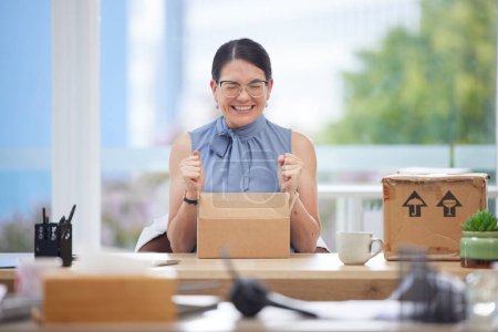 Photo for Excited, delivery and box of business woman in office happy with product from courier service, ecommerce and supply chain industry. Success, logistics and employee with cardboard package for unboxing. - Royalty Free Image